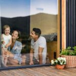 family overlooking replaced window glass