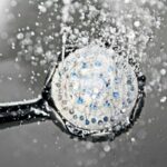 water running in a frameless sliding shower door