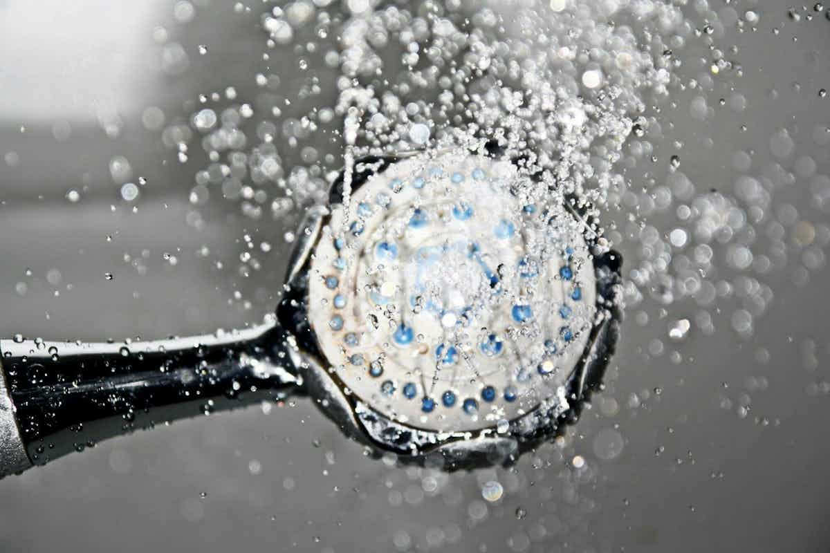 water running in a frameless sliding shower door